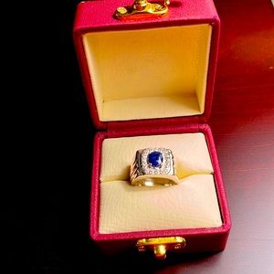 Silver colored ring with blue and white stones of unknown origin.